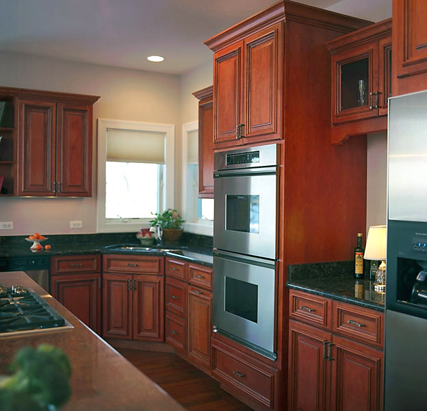 Rich cherry wood kitchen with built-ins
